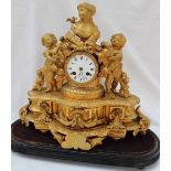 A 19th century gilt spelter mantle clock with a portrait bust to the top quiver and flaming torch,