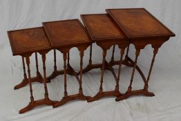 A 20th century walnut quartetto nest of tables the rectangular top on ring turned legs and splayed