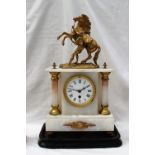 A 19th century gilt spelter and white marble mantle clock with marleys horse surmount,