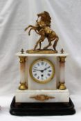 A 19th century gilt spelter and white marble mantle clock with marleys horse surmount,