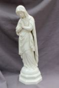 A Belleek porcelain figure modeled as the blessed Virgin Mary, Mother of God,