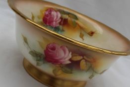A Royal Worcester bowl, painted to the interior and exterior with red and pink roses,