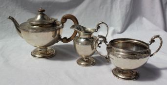 A George V silver three piece tea service, of urn shape with a spreading foot, London, 1922, F&P,