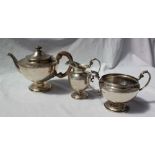 A George V silver three piece tea service, of urn shape with a spreading foot, London, 1922, F&P,