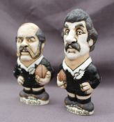 Two John Hughes pottery Groggs of New Zealand rugby players holding a rugby ball,