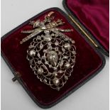 A white metal and diamond set brooch,