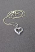 A Diamond set pendant in the shape of a heart set with baguette and brilliant cut diamonds to an