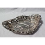 An Edward VII silver bon bon dish of oval pierced form decorated with lions heads,