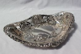 An Edward VII silver bon bon dish of oval pierced form decorated with lions heads,