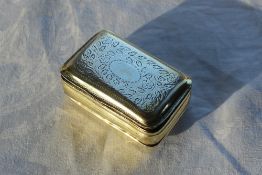 A George IV silver gilt snuff box of rectangular form, decorated with a central oval,