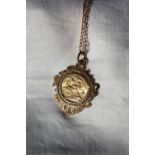 An Edward VII gold sovereign dated 1906, in a 9ct yellow gold slip setting and chain,