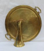 A Russian brass twin handled tray, of circular form with hammered decoration,