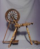 A 19th Century spinning wheel, with bobbin and ring turned legs, 83.