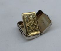 A George IV silver vinaigrette, of rectangular cushion form, decorated with scrolling leaves,
