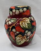 A Moorcroft ginger jar and cover decorated in white berries and red rose hips,