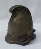A white metal inkwell in the form of a fireman's helmet, the crest with embossed dragons, 9.