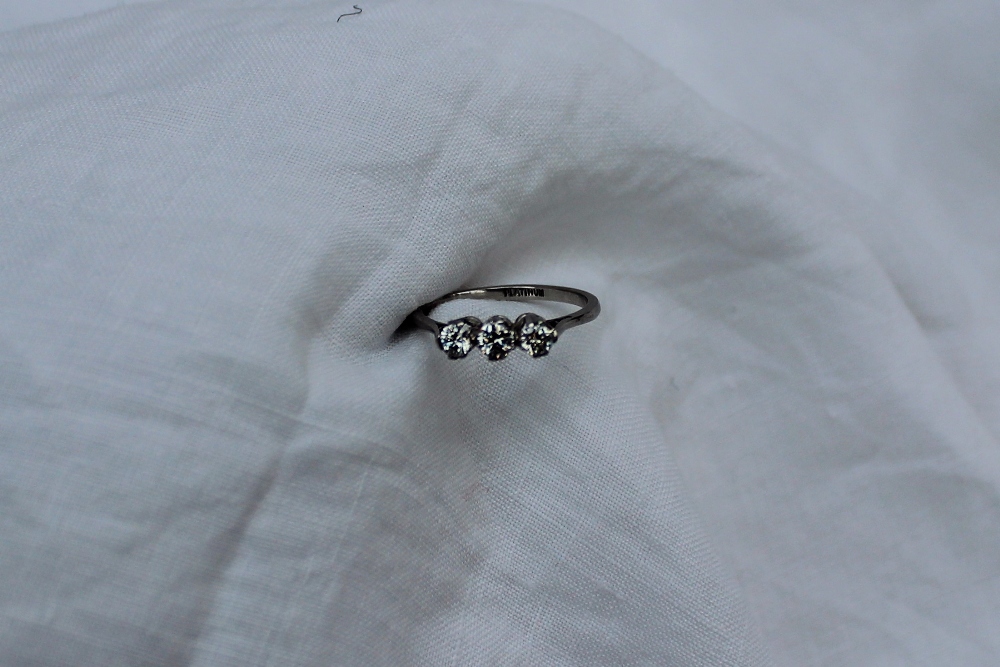 A three stone diamond ring set with three round old cut diamonds each approximately 0. - Image 2 of 3