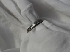 A Diamond eternity ring set with baguette and round brilliant cut diamonds to a white metal setting
