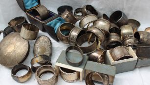 A large collection of silver napkin rings,