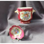 A 19th century French porcelain twin handled wine cooler painted with garden flowers to a pink