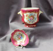 A 19th century French porcelain twin handled wine cooler painted with garden flowers to a pink