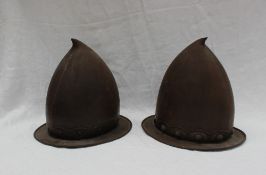 A pair of 17th century style cabasset type helmets, with raised buttons and a wide brim,