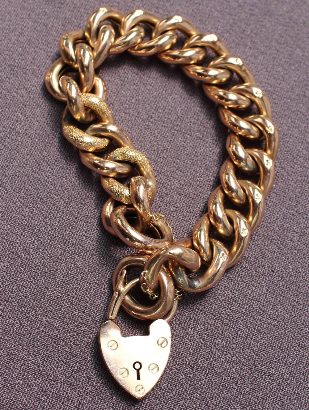 A 9ct yellow gold bracelet with textured oval links and a padlock clasp, approximately 32 grams, - Image 2 of 2
