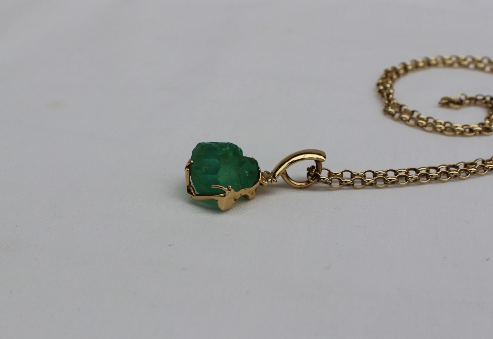 A Columbian Emerald uncut of irregular shape to a yellow metal hinged setting on a 9ct yellow gold - Image 3 of 5