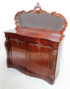A Victorian rosewood chiffonier with a mirrored back and two cupboards on a serpentine shaped base,