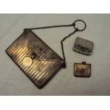 A George V silver envelope card case, with line decoration with a gilt interior on a chain and loop,