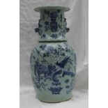 A Cantonese porcelain baluster vase, with a flared rim and dog of foo handles,