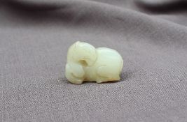 A Chinese "mutton fat" jade carving of a recumbent horse,