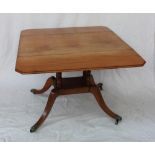 A Regency mahogany sofa table, with drop flaps on a turned column and four splayed legs,