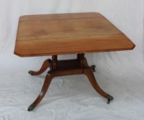 A Regency mahogany sofa table, with drop flaps on a turned column and four splayed legs,