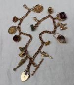 A 9ct gold Albert chain with multiple charms including fob seals,