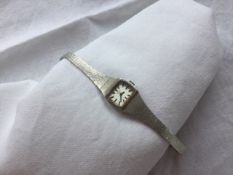 A lady's 9ct white gold Rotary wristwatch with a rectangular dial and batons,