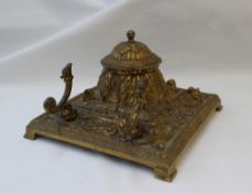 An ormolu desk standish, the domed cover cast with leaves with a ball finial,