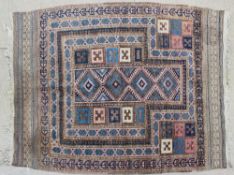 A small prayer rug with a brown ground, with geometric patterns to a multiple guard stripe border,