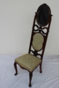 A 19th century continental walnut chair with easel mirror mounted to the back with a pad back and