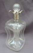 An Edwardian silver topped and engraved glass decanter, with a flared rim, and a pinched glass body,