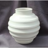 A Keith Murray style vase the stepped circular vase in ivory, impressed Made in England No.