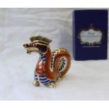 A Royal Crown Derby bone china paperweight of a coiled dragon,