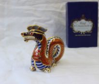 A Royal Crown Derby bone china paperweight of a coiled dragon,