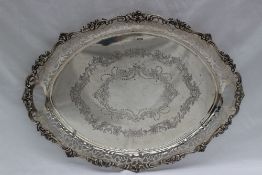 A George V silver twin handled tray, with a pierced border,