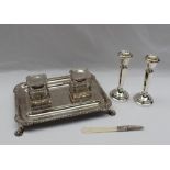 An Edward VII silver desk standish of rectangular form with a gadrooned edge and claw feet,
