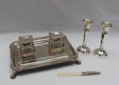 An Edward VII silver desk standish of rectangular form with a gadrooned edge and claw feet,