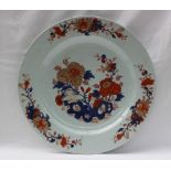 A Japanese porcelain charger, painted to the centre with flowers,