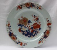 A Japanese porcelain charger, painted to the centre with flowers,
