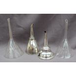 Two 19th century glass funnels together with two electroplated wine funnels