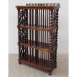 A Victorian rosewood music cabinet, with a pierced gallery above three shelves,